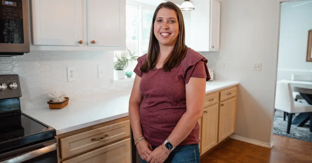 Texas homeowner standing in their newly remodeled kitchen